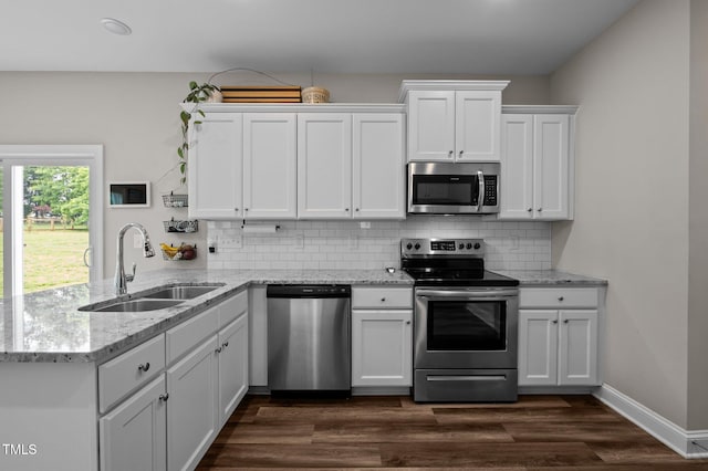 412 Carr Store Rd, Cedar Grove, NC 27231 - kitchen featuring stainless steel appliances, a sink, a peninsula, white cabinetry, and decorative backsplash