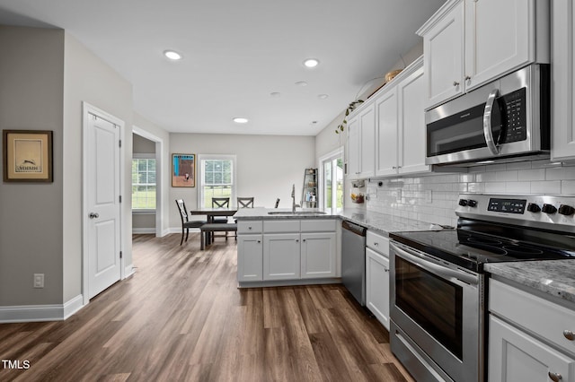 412 Carr Store Rd, Cedar Grove, NC 27231 - kitchen featuring stainless steel appliances, a sink, a peninsula, dark wood-type flooring, and tasteful backsplash