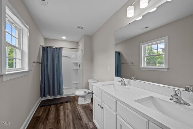 412 Carr Store Rd, Cedar Grove, NC 27231 - bathroom with toilet, a shower with curtain, wood finished floors, double vanity, and baseboards
