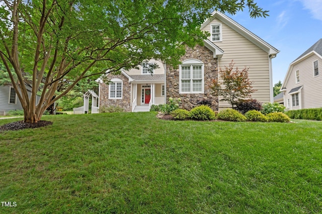 1012 Coram Fields Rd, Wake Forest, NC 27587 - view of front facade featuring stone siding and a front yard
