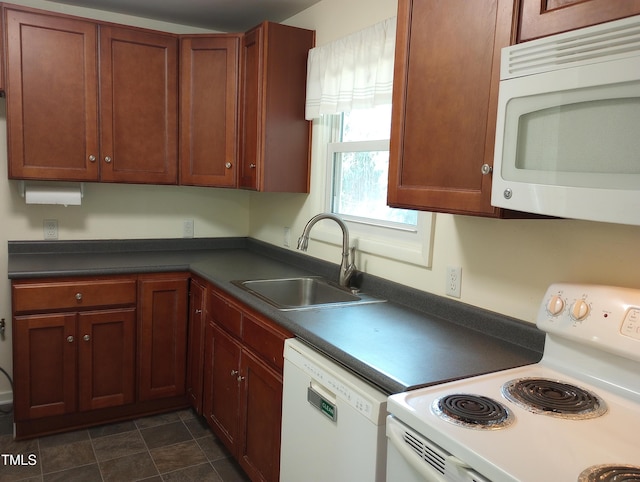 912 Dixie Trl, Raleigh, NC 27607 - kitchen with white appliances, a sink, and dark countertops