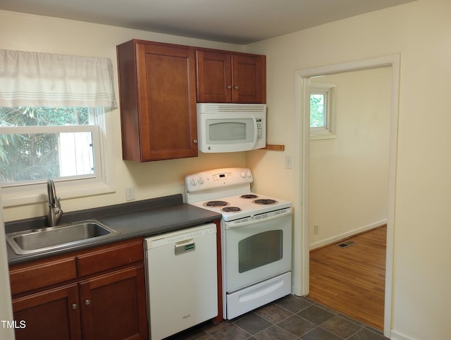 912 Dixie Trl, Raleigh, NC 27607 - kitchen featuring white appliances, a sink, and dark countertops