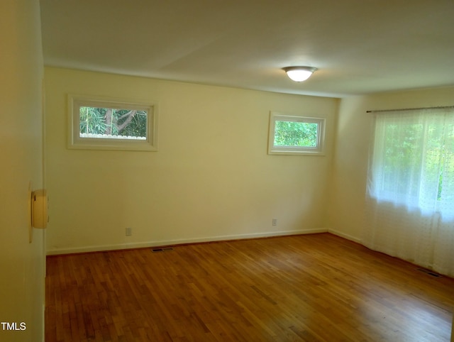 912 Dixie Trl, Raleigh, NC 27607 - unfurnished room with wood finished floors and baseboards