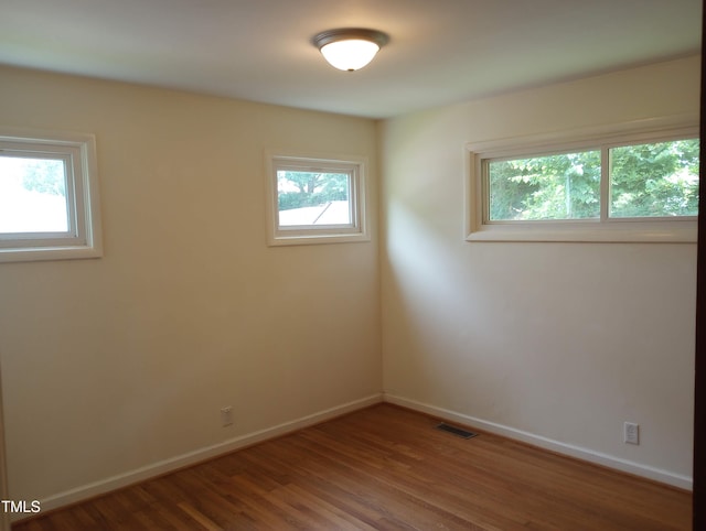 912 Dixie Trl, Raleigh, NC 27607 - spare room featuring wood finished floors and baseboards