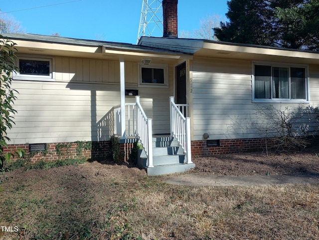 912 Dixie Trl, Raleigh, NC 27607 - doorway to property featuring crawl space and a chimney