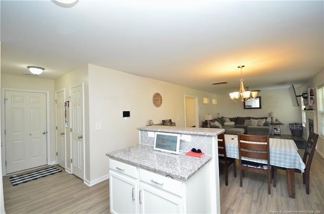 109 Red Coat Dr, Cameron, NC 28326 - kitchen with light wood-type flooring, a chandelier, white cabinets, and baseboards