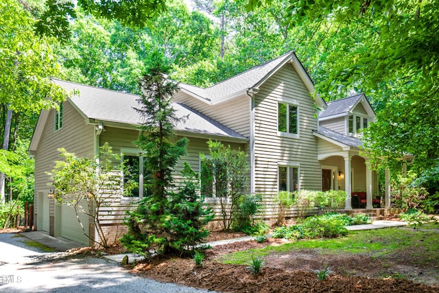 574 Chatham Dr, Chapel Hill, NC 27516 - view of front of home with covered porch, asphalt driveway, a shingled roof, and an attached garage