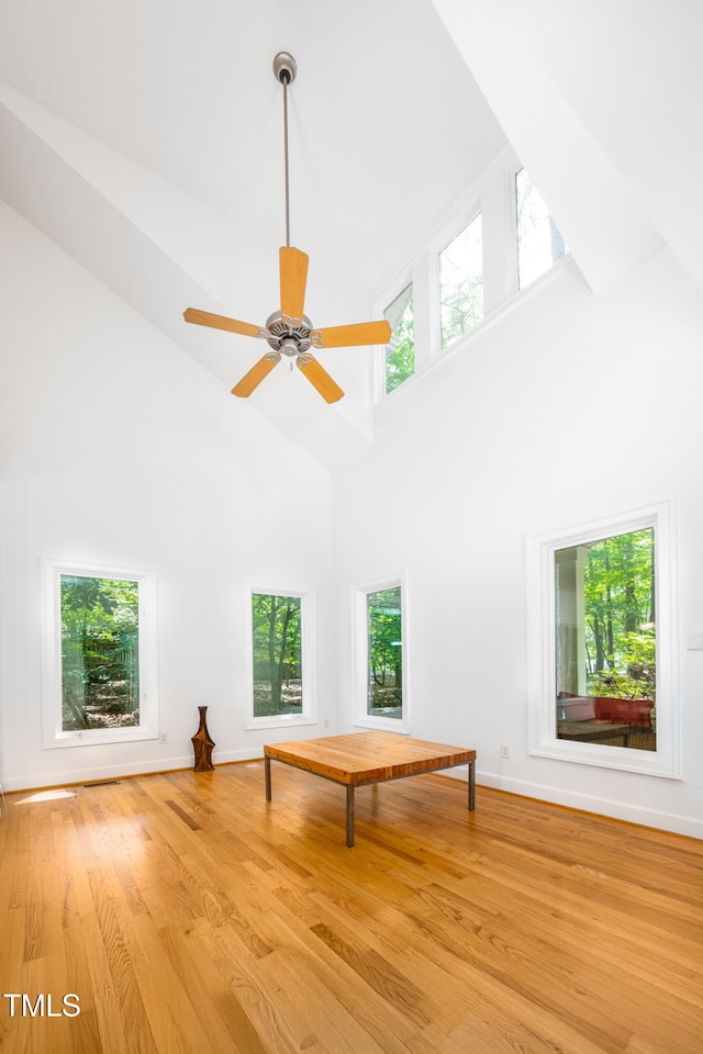 574 Chatham Dr, Chapel Hill, NC 27516 - unfurnished room featuring a towering ceiling, wood finished floors, baseboards, and a ceiling fan