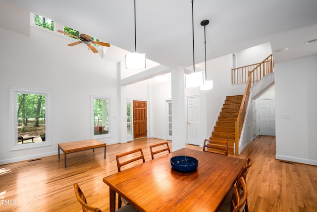 574 Chatham Dr, Chapel Hill, NC 27516 - dining room with a ceiling fan, stairway, light wood-type flooring, a high ceiling, and baseboards