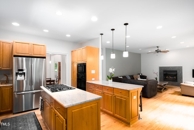 574 Chatham Dr, Chapel Hill, NC 27516 - kitchen featuring black appliances, a kitchen island, light wood-style flooring, a ceiling fan, and recessed lighting