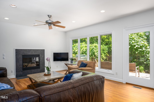574 Chatham Dr, Chapel Hill, NC 27516 - living room with ceiling fan, recessed lighting, light wood-type flooring, a fireplace with flush hearth, and baseboards