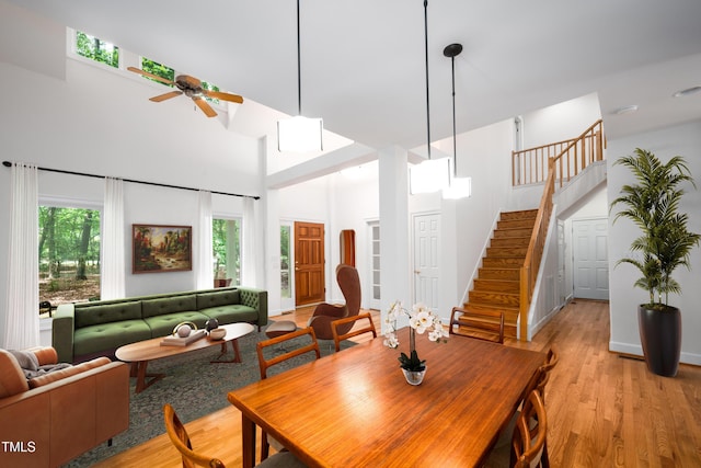 574 Chatham Dr, Chapel Hill, NC 27516 - dining area featuring ceiling fan, a high ceiling, healthy amount of natural light, stairs, and light wood finished floors