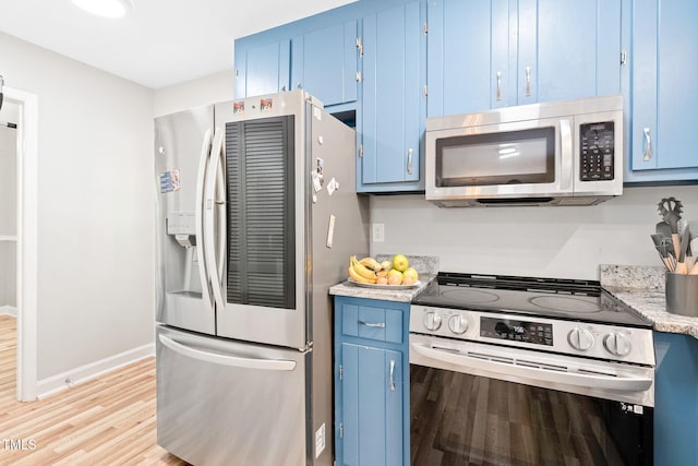 114 Bonaparte Dr, Hillsborough, NC 27278 - kitchen with blue cabinets, appliances with stainless steel finishes, light wood-style flooring, and light countertops
