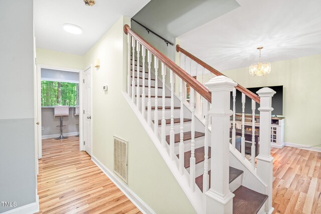 114 Bonaparte Dr, Hillsborough, NC 27278 - staircase featuring wood finished floors, a chandelier, and baseboards