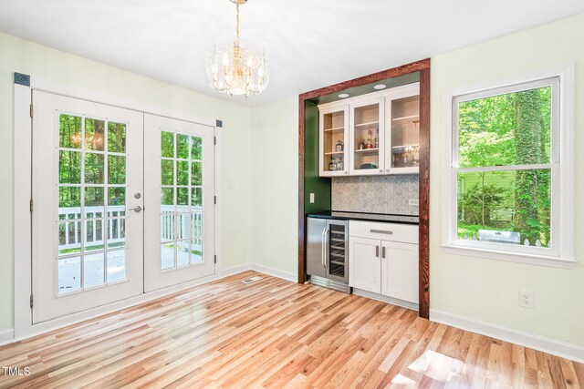 114 Bonaparte Dr, Hillsborough, NC 27278 - indoor dry bar featuring beverage cooler, french doors, baseboards, and backsplash