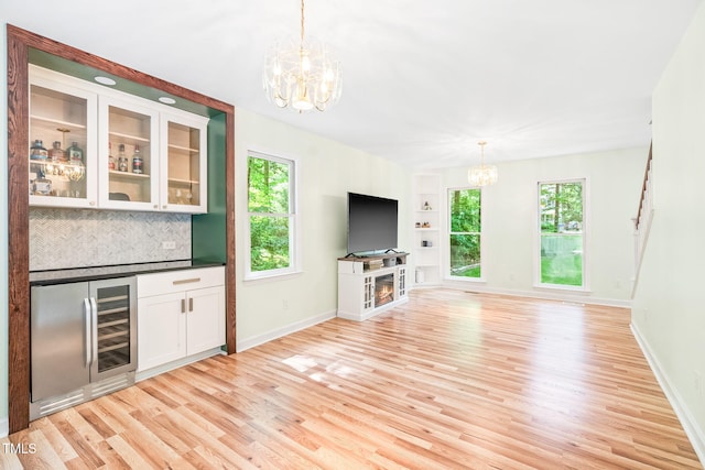 114 Bonaparte Dr, Hillsborough, NC 27278 - bar with a chandelier, beverage cooler, light wood-type flooring, and tasteful backsplash
