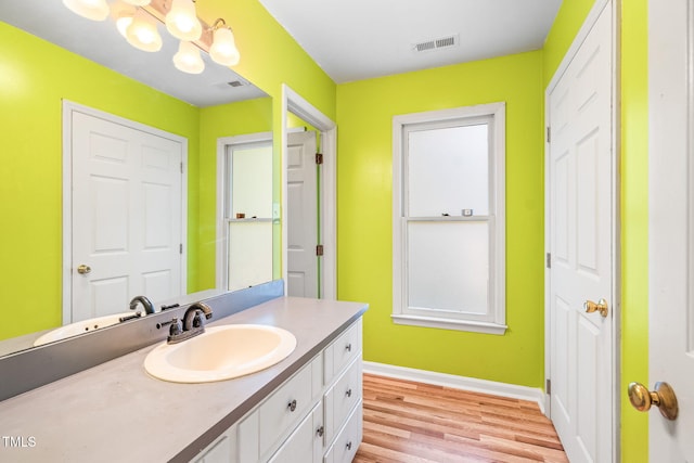 114 Bonaparte Dr, Hillsborough, NC 27278 - bathroom featuring a chandelier, wood finished floors, baseboards, and vanity