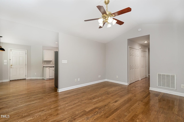 2805 Evans St, Durham, NC 27705 - unfurnished living room featuring a ceiling fan, vaulted ceiling, wood finished floors, and baseboards