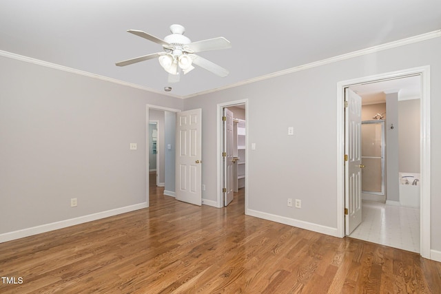 2805 Evans St, Durham, NC 27705 - unfurnished bedroom featuring crown molding, a spacious closet, light wood-style flooring, and baseboards