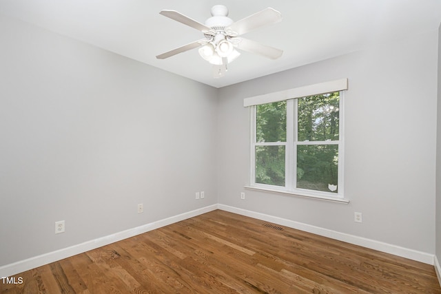 2805 Evans St, Durham, NC 27705 - spare room featuring baseboards, wood finished floors, and a ceiling fan