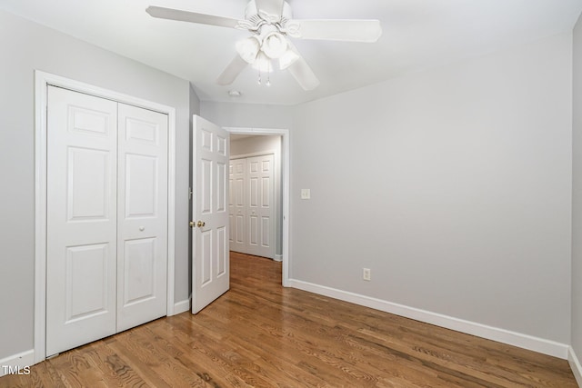 2805 Evans St, Durham, NC 27705 - unfurnished bedroom with baseboards, wood finished floors, a closet, and a ceiling fan