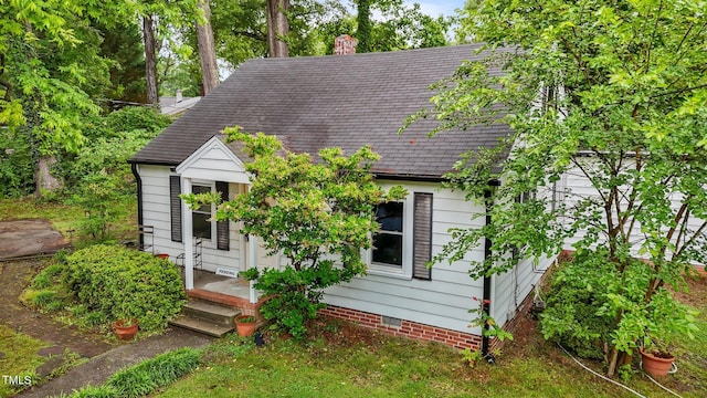 1105 Hawthorne Ln, Burlington, NC 27215 - new england style home featuring crawl space, roof with shingles, and a chimney