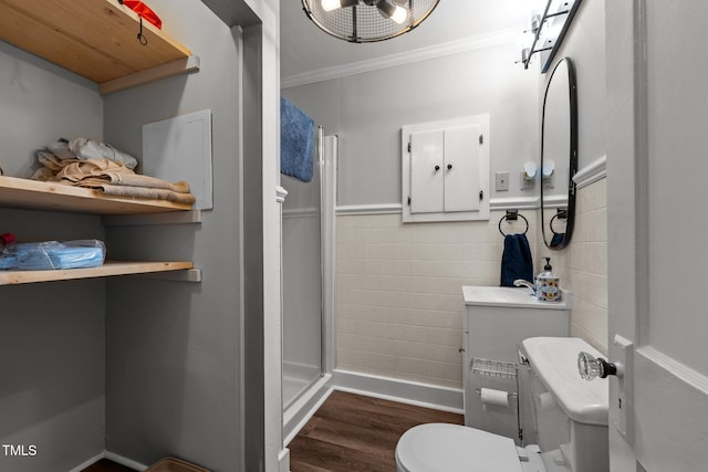 1105 Hawthorne Ln, Burlington, NC 27215 - bathroom with a stall shower, wood finished floors, toilet, ornamental molding, and a sink