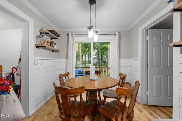 1105 Hawthorne Ln, Burlington, NC 27215 - dining space with light wood-style flooring, a wainscoted wall, ornamental molding, and wood walls