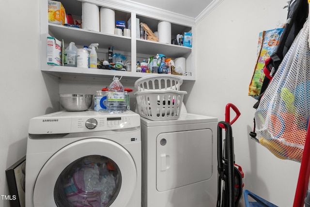 1105 Hawthorne Ln, Burlington, NC 27215 - laundry room with washing machine and clothes dryer and crown molding