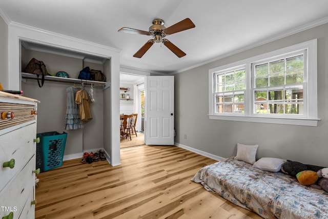1105 Hawthorne Ln, Burlington, NC 27215 - bedroom with a closet, ornamental molding, light wood-type flooring, baseboards, and ceiling fan