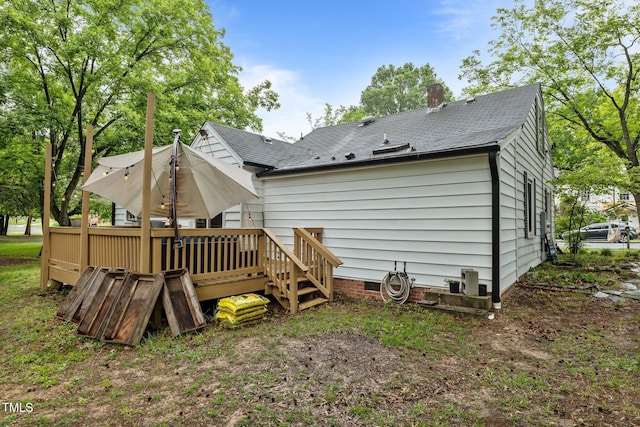 1105 Hawthorne Ln, Burlington, NC 27215 - back of property featuring a deck, a chimney, a shingled roof, and crawl space