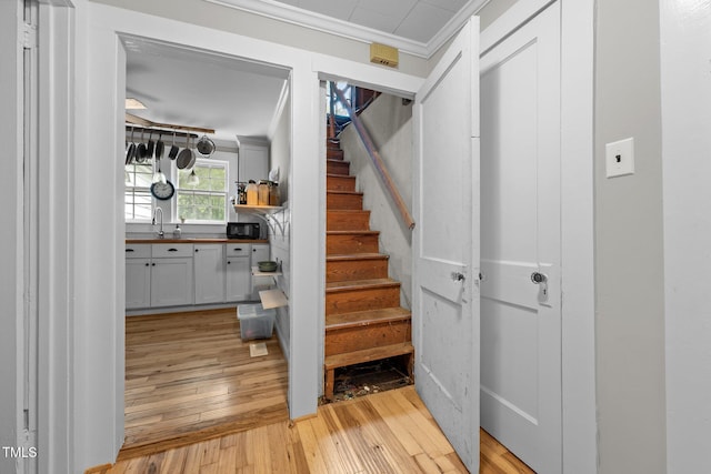1105 Hawthorne Ln, Burlington, NC 27215 - staircase featuring wood-type flooring and crown molding