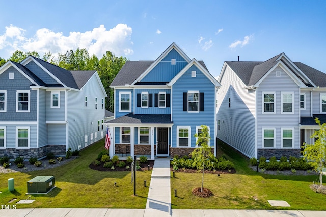 279 Edge Of Auburn Blvd, Raleigh, NC 27610 - view of front facade featuring board and batten siding, stone siding, and a front yard