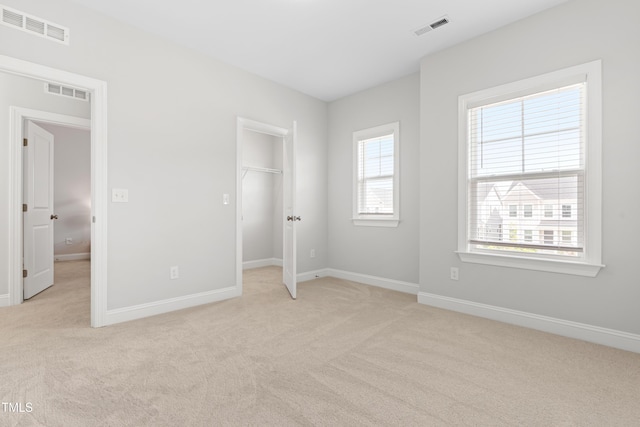 279 Edge Of Auburn Blvd, Raleigh, NC 27610 - unfurnished bedroom featuring light colored carpet, baseboards, and a spacious closet