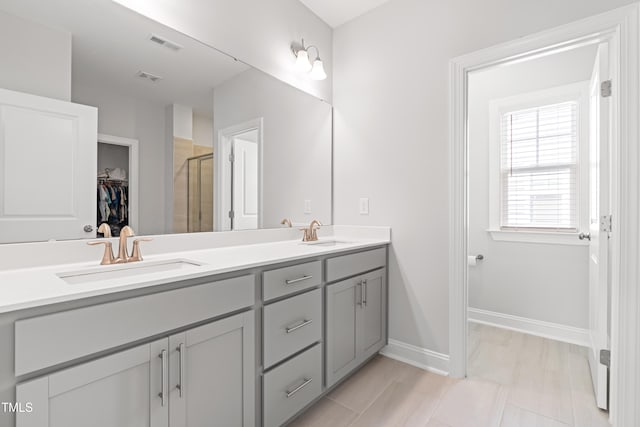 279 Edge Of Auburn Blvd, Raleigh, NC 27610 - full bath featuring double vanity, a stall shower, a spacious closet, and baseboards