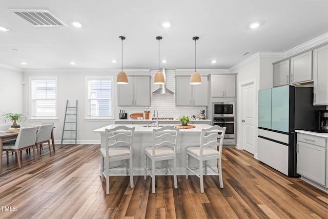 279 Edge Of Auburn Blvd, Raleigh, NC 27610 - kitchen featuring stainless steel appliances, gray cabinetry, wall chimney range hood, ornamental molding, and light countertops