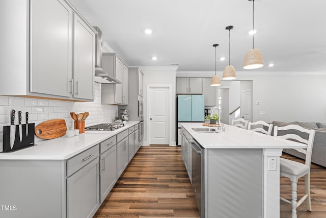 279 Edge Of Auburn Blvd, Raleigh, NC 27610 - kitchen featuring a sink, gray cabinets, a kitchen bar, wall chimney range hood, and dark wood-type flooring