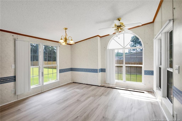 6131 Twiggs Ct, Hope Mills, NC 28348 - empty room with a chandelier, ornamental molding, a textured ceiling, healthy amount of natural light, and wood finished floors