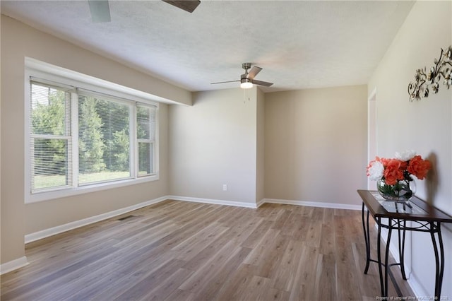 408 Harril Cir, Spring Lake, NC 28390 - unfurnished room featuring a ceiling fan, wood finished floors, baseboards, and a textured ceiling