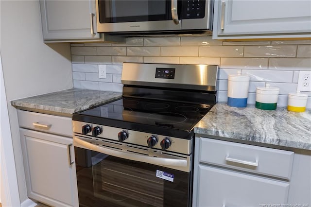 408 Harril Cir, Spring Lake, NC 28390 - kitchen with appliances with stainless steel finishes and backsplash