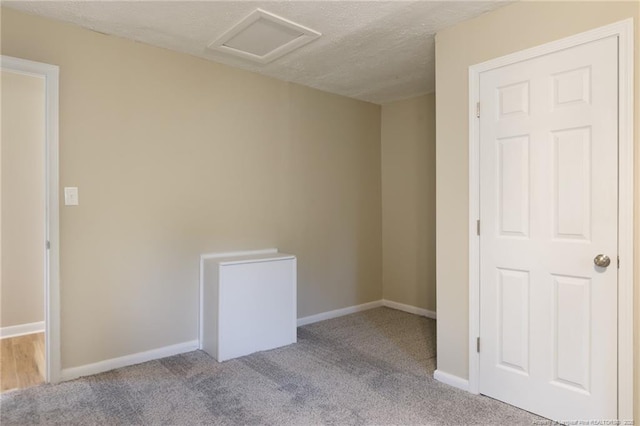 408 Harril Cir, Spring Lake, NC 28390 - carpeted spare room featuring attic access, baseboards, and a textured ceiling