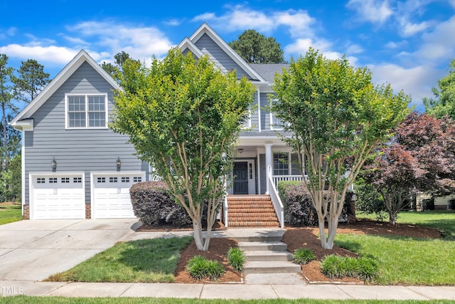 805 Alden Bridge Dr, Cary, NC 27519 - view of property hidden behind natural elements with a garage, concrete driveway, a porch, a front lawn, and stairs