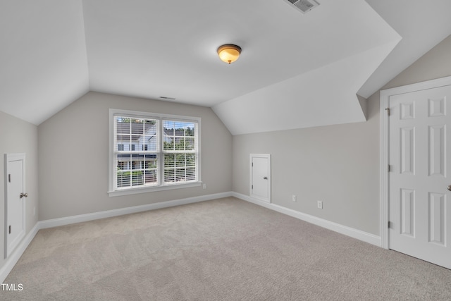 805 Alden Bridge Dr, Cary, NC 27519 - additional living space with lofted ceiling, light colored carpet, and baseboards