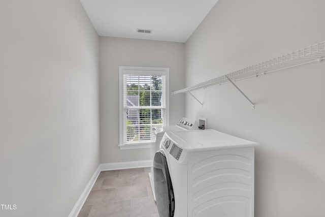 805 Alden Bridge Dr, Cary, NC 27519 - washroom with baseboards, washing machine and dryer, and light tile patterned floors