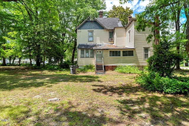 903 Nicholas St, Henderson, NC 27536 - rear view of house with entry steps, a chimney, and a lawn