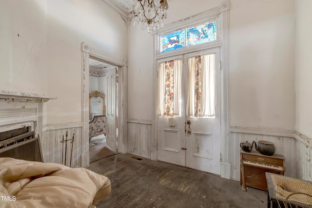 903 Nicholas St, Henderson, NC 27536 - entrance foyer with wainscoting, a chandelier, hardwood / wood-style flooring, and a towering ceiling