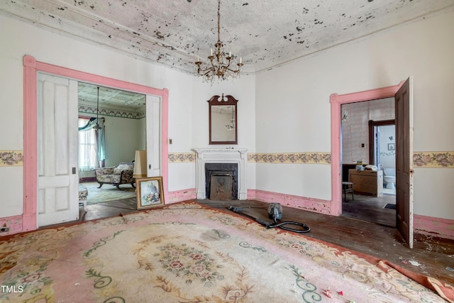 903 Nicholas St, Henderson, NC 27536 - unfurnished living room with a chandelier and a fireplace