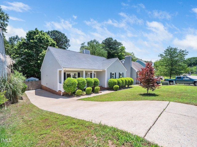 8312 Bellingham Cir, Raleigh, NC 27615 - view of front of property featuring driveway, roof with shingles, and a chimney