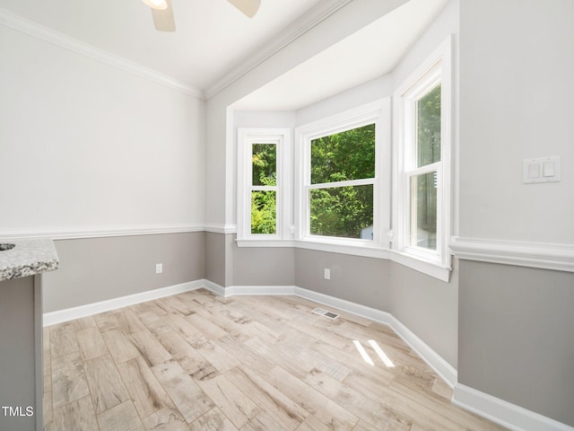 8312 Bellingham Cir, Raleigh, NC 27615 - empty room featuring light wood-type flooring, crown molding, baseboards, and ceiling fan