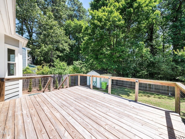 8312 Bellingham Cir, Raleigh, NC 27615 - deck with a fenced backyard, an outbuilding, and view of wooded area